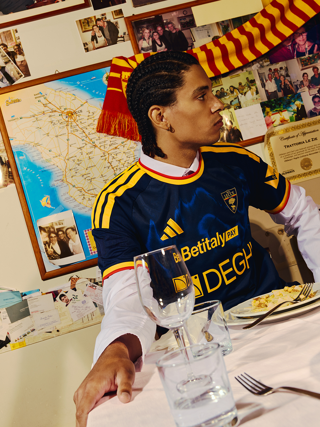 The 2026-27 adidas third shirt worn at the table in a Salento trattoria
